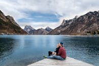 Couple enjoying a scenic view of the lake and mountains in Ebensee, Austria.