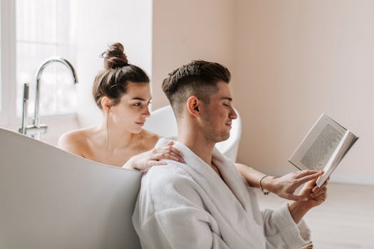 A serene moment of a couple reading in a modern bathroom, highlighting relaxation and togetherness.